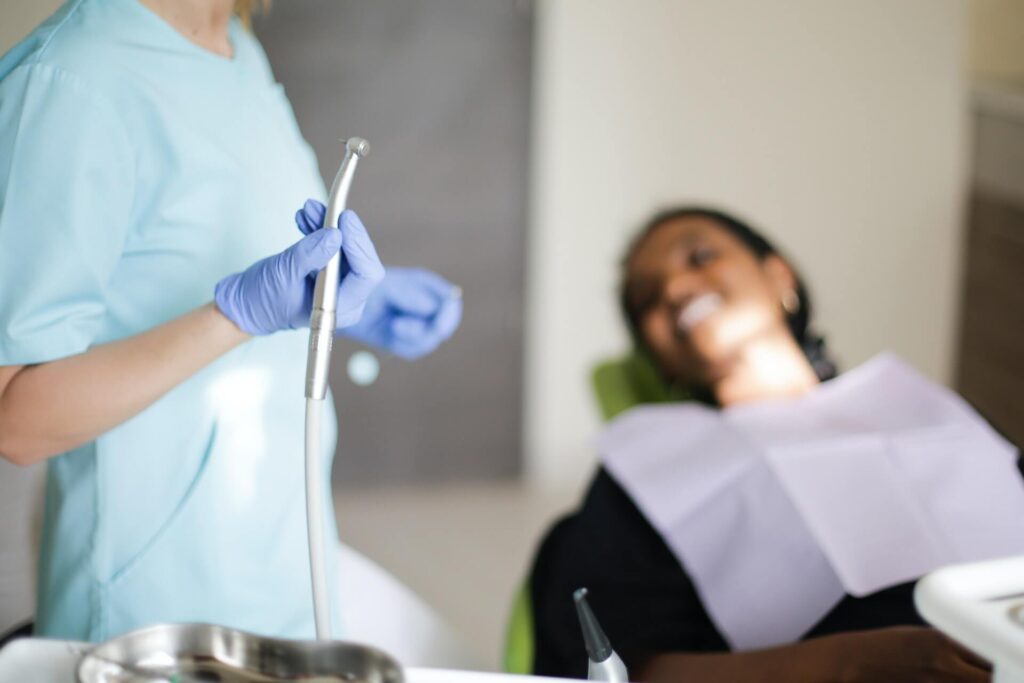 Una dentista a punto de revisar una caries a una paciente.
